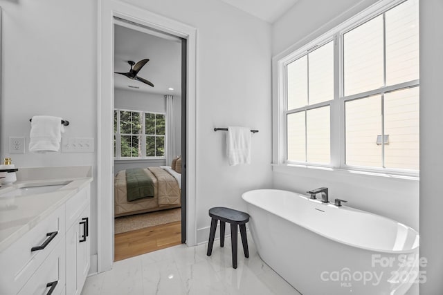 3949 Plainview Rd, Charlotte, NC 28208 - full bathroom with marble look tiles, a soaking tub, vanity, a ceiling fan, and ensuite bath