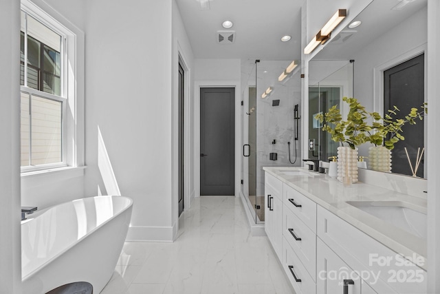 3949 Plainview Rd, Charlotte, NC 28208 - full bath featuring a stall shower, a freestanding tub, double vanity, marble finish flooring, and recessed lighting
