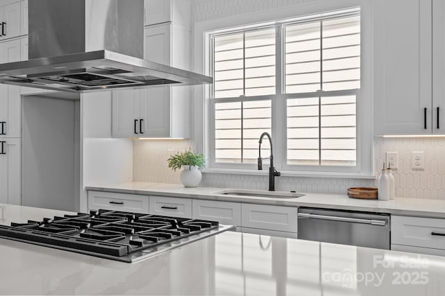 3949 Plainview Rd, Charlotte, NC 28208 - kitchen featuring wall chimney exhaust hood, appliances with stainless steel finishes, backsplash, light countertops, and white cabinetry