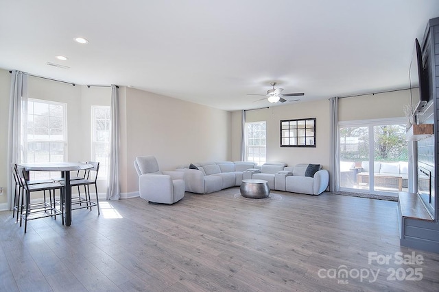 4017 Avis Way, Monroe, NC 28110 - living room featuring a ceiling fan, recessed lighting, wood finished floors, and a fireplace