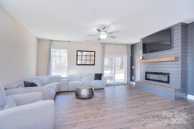 4017 Avis Way, Monroe, NC 28110 - living area featuring wood finished floors, ceiling fan, and a fireplace
