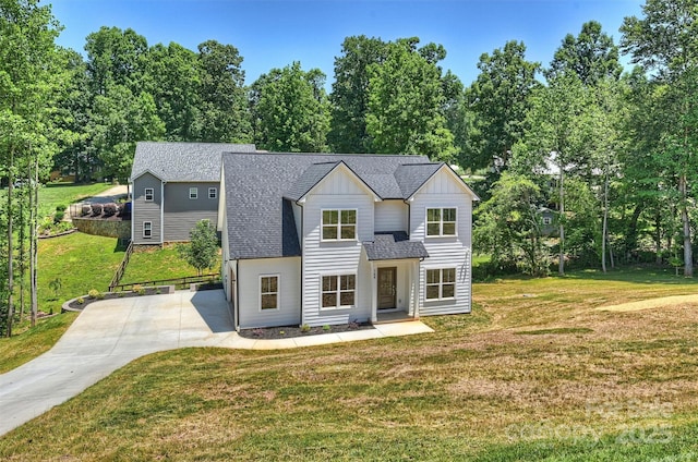 164 Meadow Glen Dr, Troutman, NC 28166 - view of front of home featuring board and batten siding, a shingled roof, view of scattered trees, and a front lawn