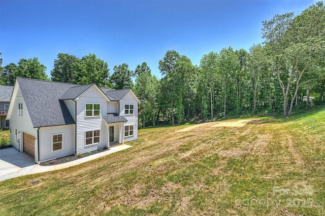 164 Meadow Glen Dr, Troutman, NC 28166 - view of front of home featuring concrete driveway, a front lawn, an attached garage, a shingled roof, and board and batten siding