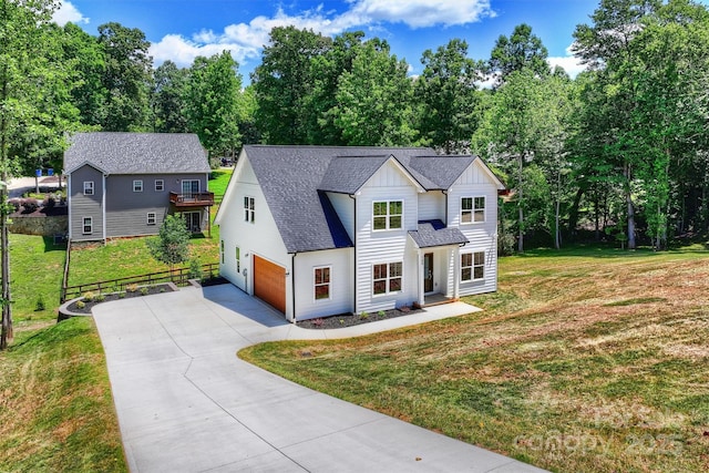 164 Meadow Glen Dr, Troutman, NC 28166 - modern inspired farmhouse with board and batten siding, concrete driveway, view of wooded area, a shingled roof, and an attached garage