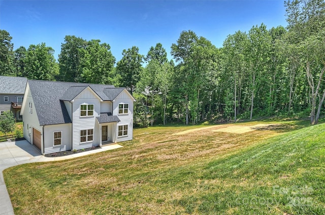 164 Meadow Glen Dr, Troutman, NC 28166 - view of front facade featuring concrete driveway, roof with shingles, and a front yard