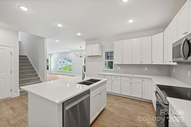 164 Meadow Glen Dr, Troutman, NC 28166 - kitchen with appliances with stainless steel finishes, light wood-type flooring, white cabinetry, light countertops, and recessed lighting