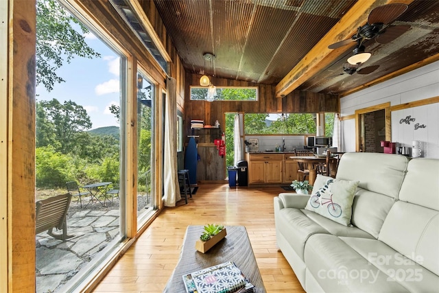 553 Paradise Mountain Rd, Canton, NC 28716 - living area with wood walls, light wood-style flooring, vaulted ceiling, and a ceiling fan