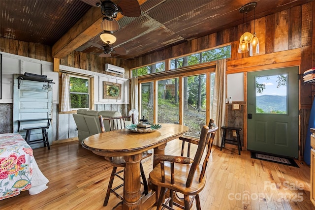 553 Paradise Mountain Rd, Canton, NC 28716 - dining area with a wall unit AC, ceiling fan, a wooden ceiling with exposed beams, wooden walls, and light wood-type flooring