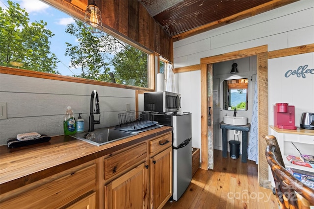 553 Paradise Mountain Rd, Canton, NC 28716 - kitchen with wood counters, stainless steel microwave, light wood-style floors, and brown cabinets