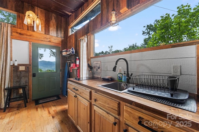 553 Paradise Mountain Rd, Canton, NC 28716 - kitchen with wood walls, light wood-style flooring, wooden ceiling, tasteful backsplash, and hanging light fixtures