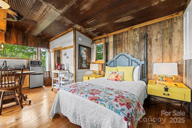 553 Paradise Mountain Rd, Canton, NC 28716 - bedroom with vaulted ceiling, freestanding refrigerator, wooden walls, wood-type flooring, and wooden ceiling