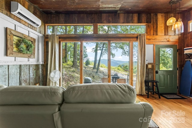 553 Paradise Mountain Rd, Canton, NC 28716 - living area with an AC wall unit, wooden walls, a mountain view, wood finished floors, and wooden ceiling