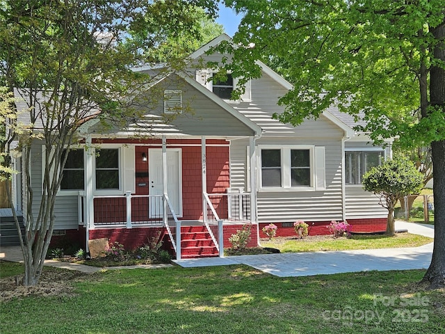 3824 Freedom Dr, Charlotte, NC 28208 - view of front facade with crawl space, a front lawn, and covered porch