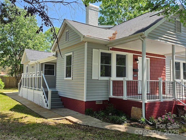 3824 Freedom Dr, Charlotte, NC 28208 - view of side of property featuring crawl space, a chimney, and a shingled roof