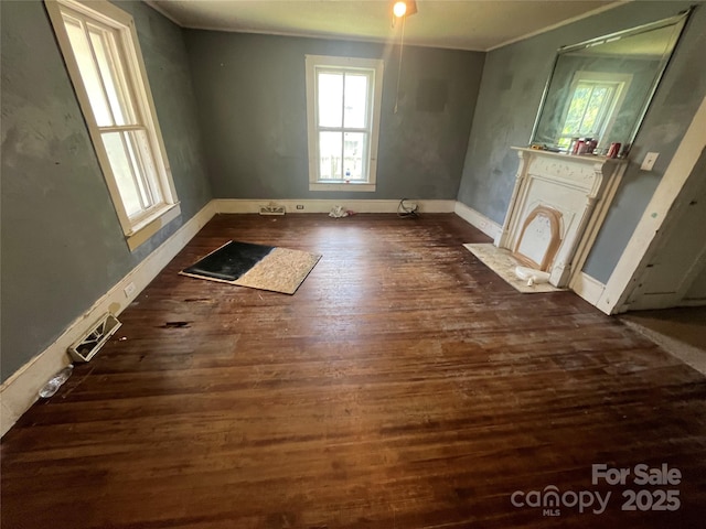 119 Hemlock Ave, Kannapolis, NC 28081 - unfurnished room with crown molding, dark wood finished floors, and a fireplace with flush hearth