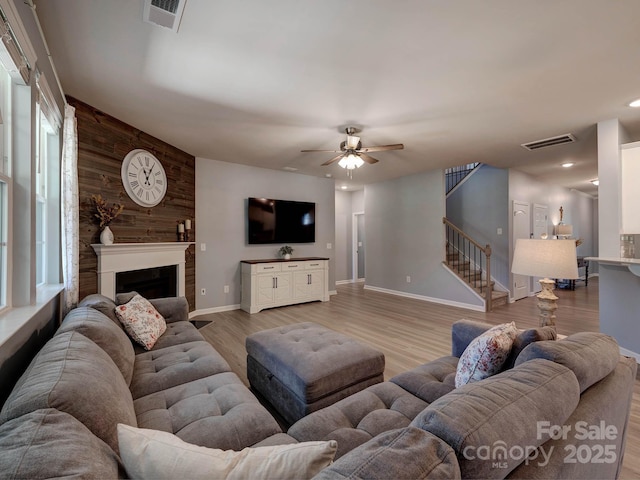 1324 Mona Vale Dr, Huntersville, NC 28078 - living room with stairs, a ceiling fan, light wood-style floors, a fireplace, and recessed lighting