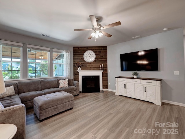 1324 Mona Vale Dr, Huntersville, NC 28078 - living area featuring a ceiling fan, light wood finished floors, and a fireplace with flush hearth
