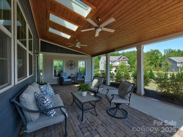 1324 Mona Vale Dr, Huntersville, NC 28078 - sunroom with outdoor lounge area, a skylight, ceiling fan, and lofted ceiling