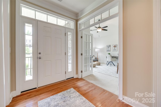 3905 Hounslow Ln, Harrisburg, NC 28075 - entryway featuring plenty of natural light, wood finished floors, a ceiling fan, and crown molding