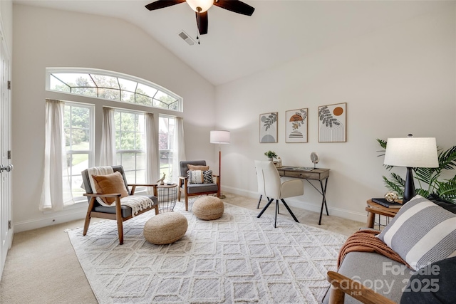 3905 Hounslow Ln, Harrisburg, NC 28075 - living area with light colored carpet, plenty of natural light, a ceiling fan, and high vaulted ceiling