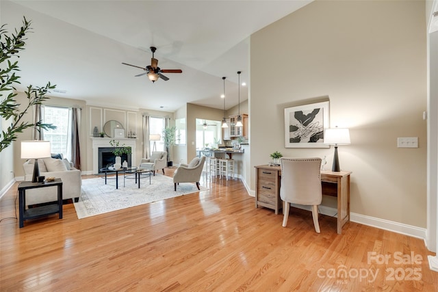 3905 Hounslow Ln, Harrisburg, NC 28075 - living area featuring ceiling fan, plenty of natural light, a fireplace, light wood-type flooring, and lofted ceiling