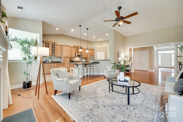3905 Hounslow Ln, Harrisburg, NC 28075 - living room featuring plenty of natural light, light wood-type flooring, high vaulted ceiling, and recessed lighting