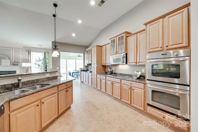3905 Hounslow Ln, Harrisburg, NC 28075 - kitchen featuring stainless steel appliances, vaulted ceiling, light brown cabinets, dark stone counters, and glass insert cabinets