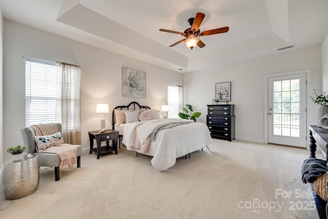 3905 Hounslow Ln, Harrisburg, NC 28075 - bedroom featuring a raised ceiling, access to outside, multiple windows, and light colored carpet