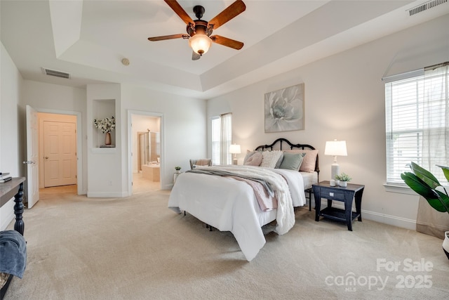 3905 Hounslow Ln, Harrisburg, NC 28075 - bedroom with a raised ceiling, light colored carpet, connected bathroom, and ceiling fan