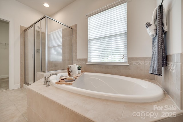 3905 Hounslow Ln, Harrisburg, NC 28075 - bathroom featuring a stall shower, a bath, tile patterned flooring, recessed lighting, and a walk in closet