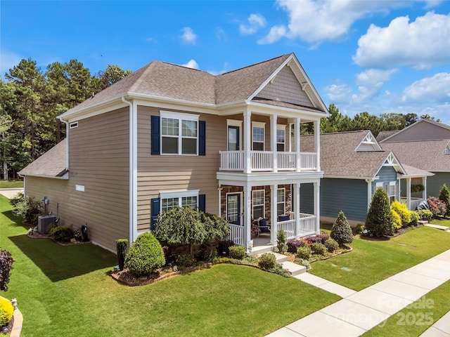 282 Harrison Ln, Locust, NC 28097 - view of front of property featuring a porch, a balcony, a front lawn, and a shingled roof
