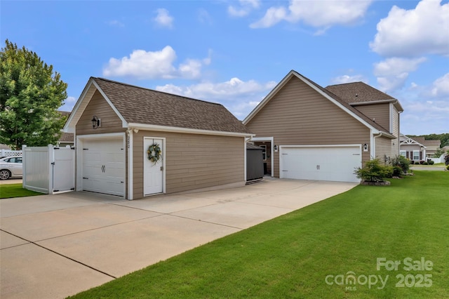 282 Harrison Ln, Locust, NC 28097 - view of side of home featuring a yard, concrete driveway, and a shingled roof