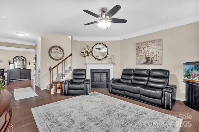 282 Harrison Ln, Locust, NC 28097 - living area with a ceiling fan, crown molding, a glass covered fireplace, stairs, and dark wood-style floors