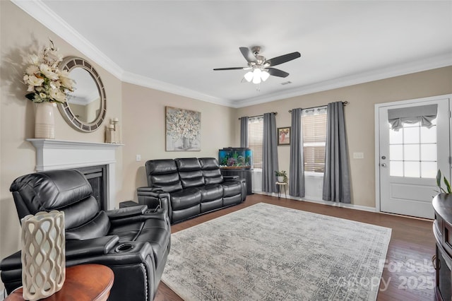 282 Harrison Ln, Locust, NC 28097 - living area featuring plenty of natural light, ceiling fan, ornamental molding, dark wood-type flooring, and a fireplace