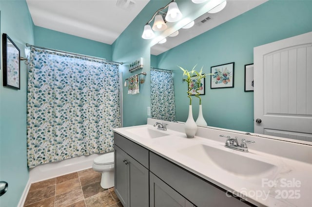 282 Harrison Ln, Locust, NC 28097 - bathroom with double vanity, shower / bath combo with shower curtain, and stone finish floors