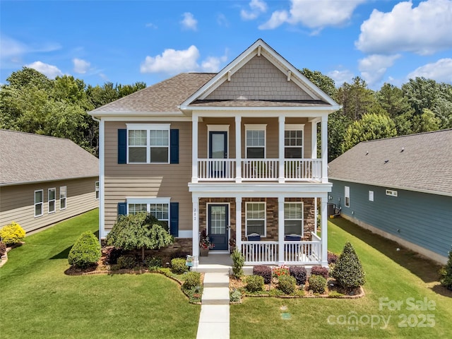 282 Harrison Ln, Locust, NC 28097 - view of front of property with a porch, a balcony, a front lawn, and stone siding