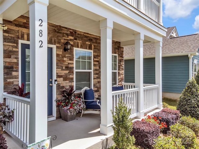 282 Harrison Ln, Locust, NC 28097 - property entrance featuring covered porch, roof with shingles, and stone siding