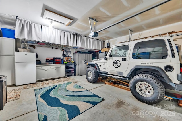 282 Harrison Ln, Locust, NC 28097 - garage with freestanding refrigerator and a garage door opener