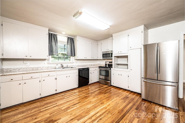 1036 11th Street Circle Dr NW, Hickory, NC 28601 - kitchen with appliances with stainless steel finishes, light countertops, light wood-style flooring, and white cabinetry