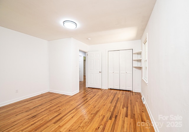 1036 11th Street Circle Dr NW, Hickory, NC 28601 - unfurnished bedroom featuring light wood-style flooring and a closet