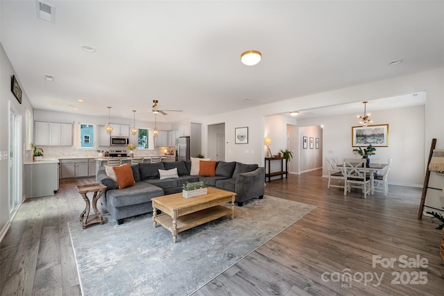 5499 Angus Dr, Midland, NC 28107 - living area featuring wood finished floors, a ceiling fan, recessed lighting, and a chandelier