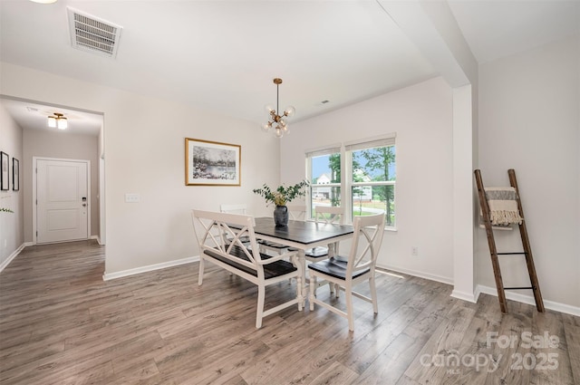 5499 Angus Dr, Midland, NC 28107 - dining area with wood finished floors and a chandelier