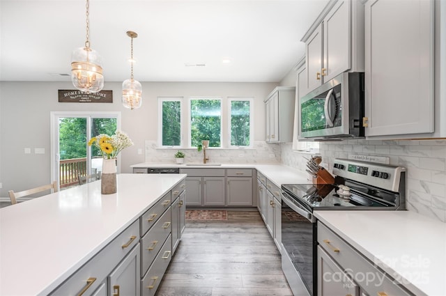 5499 Angus Dr, Midland, NC 28107 - kitchen with appliances with stainless steel finishes, gray cabinets, healthy amount of natural light, light wood finished floors, and recessed lighting