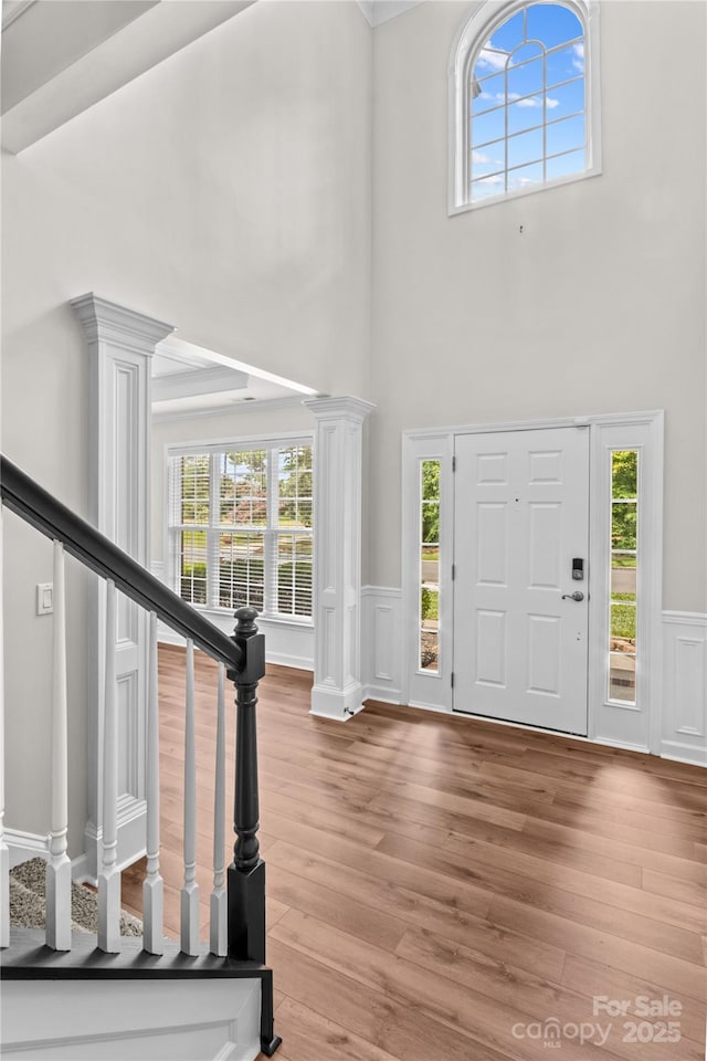 1011 Wadsworth Ln, Indian Trail, NC 28079 - entryway featuring healthy amount of natural light, wainscoting, stairs, wood finished floors, and a towering ceiling