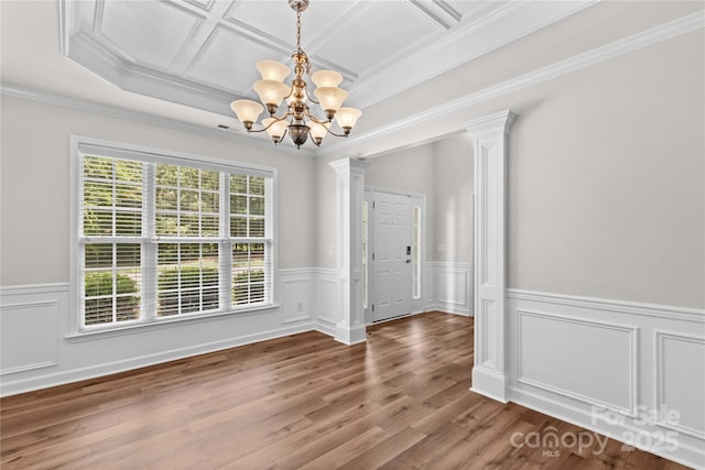 1011 Wadsworth Ln, Indian Trail, NC 28079 - empty room featuring ornate columns, a chandelier, wood finished floors, wainscoting, and ornamental molding