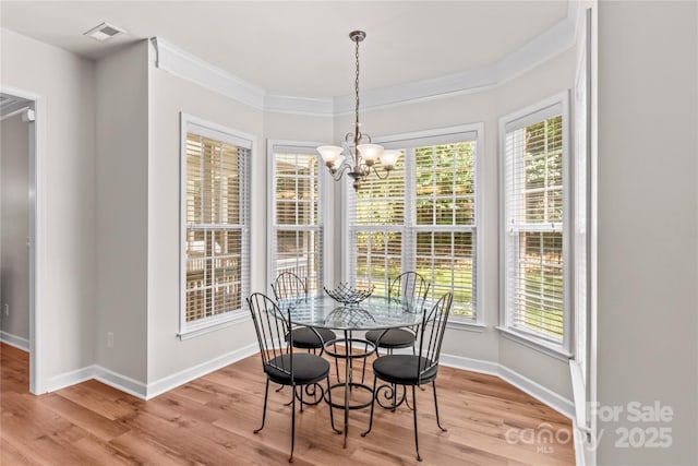 1011 Wadsworth Ln, Indian Trail, NC 28079 - dining room featuring light wood-style flooring, a chandelier, and ornamental molding