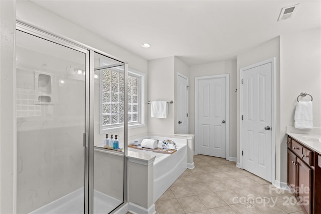 1011 Wadsworth Ln, Indian Trail, NC 28079 - full bathroom with a stall shower, vanity, a garden tub, and tile patterned floors