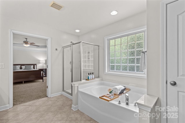 1011 Wadsworth Ln, Indian Trail, NC 28079 - bathroom featuring ensuite bath, a shower stall, a garden tub, ceiling fan, and tile patterned flooring