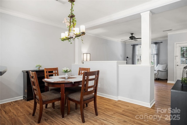 11021 Dundarrach Ln Unit 40, Charlotte, NC 28277 - dining space with ornate columns, wood finished floors, ornamental molding, a ceiling fan, and a chandelier