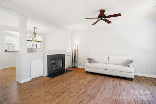 11021 Dundarrach Ln Unit 40, Charlotte, NC 28277 - living room featuring ornamental molding, light wood-style flooring, a ceiling fan, a chandelier, and ornate columns